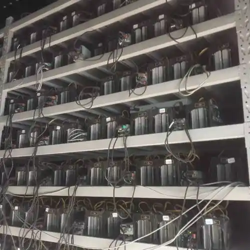 A large cryptocurrency mining farm located in a European country with rows of mining rigs visible inside.